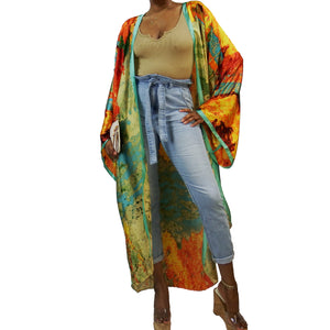 A woman models a flowing kimono robe in green and gold, featuring an abstract art print and mint-colored trim. The kimono jacket drapes elegantly.

A woman showcases a green and gold kimono robe with a striking abstract art print and mint-colored trim, highlighting the flowing fit of the kimono cardigan.