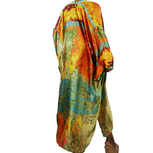 A woman models a flowing kimono robe in green and gold, featuring an abstract art print and mint-colored trim. The kimono jacket drapes elegantly.

A woman showcases a green and gold kimono robe with a striking abstract art print and mint-colored trim, highlighting the flowing fit of the kimono cardigan.