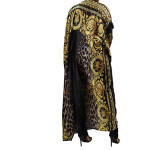 A woman models a luxurious black kimono robe adorned with a gold damask and leopard pattern, flowing gracefully for an elegant and bold statement.

A model showcases a black kimono jacket with gold damask and leopard accents, offering a stunning blend of luxury and modern chic in a flowing design.