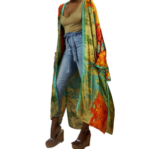 A woman models a flowing kimono robe in green and gold, featuring an abstract art print and mint-colored trim. The kimono jacket drapes elegantly.

A woman showcases a green and gold kimono robe with a striking abstract art print and mint-colored trim, highlighting the flowing fit of the kimono cardigan.
