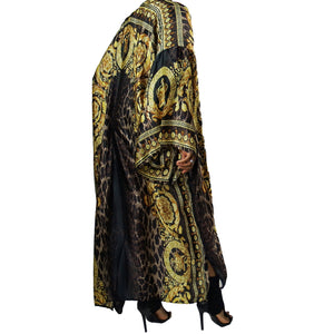 A woman models a luxurious black kimono robe adorned with a gold damask and leopard pattern, flowing gracefully for an elegant and bold statement.

A model showcases a black kimono jacket with gold damask and leopard accents, offering a stunning blend of luxury and modern chic in a flowing design.