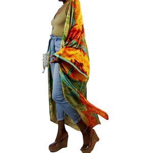 A woman models a flowing kimono robe in green and gold, featuring an abstract art print and mint-colored trim. The kimono jacket drapes elegantly.

A woman showcases a green and gold kimono robe with a striking abstract art print and mint-colored trim, highlighting the flowing fit of the kimono cardigan.