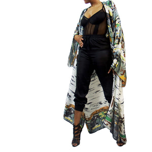 A woman models a luxury Japanese kimono robe in white with black trim, featuring subtle yellow and green tones with an abstract urban skyline design.