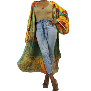 A woman models a flowing kimono robe in green and gold, featuring an abstract art print and mint-colored trim. The kimono jacket drapes elegantly.

A woman showcases a green and gold kimono robe with a striking abstract art print and mint-colored trim, highlighting the flowing fit of the kimono cardigan.