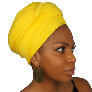 A woman models a bright yellow jersey knit stretch African headwrap, offering a bold and vibrant style with a soft, stretchy fit for comfort and versatility.