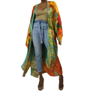 A woman models a flowing kimono robe in green and gold, featuring an abstract art print and mint-colored trim. The kimono jacket drapes elegantly.

A woman showcases a green and gold kimono robe with a striking abstract art print and mint-colored trim, highlighting the flowing fit of the kimono cardigan.